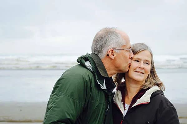 A senior couple sharing an affectionate moment by the sea